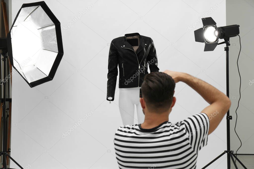 Professional photographer taking picture of ghost mannequin with stylish clothes in modern photo 