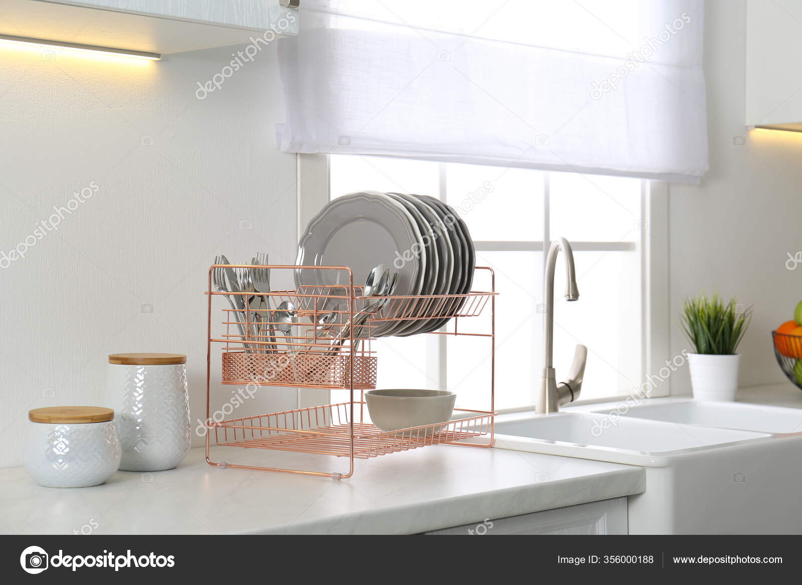 https://st3.depositphotos.com/16122460/35600/i/1600/depositphotos_356000188-stock-photo-clean-dishes-drying-rack-modern.jpg