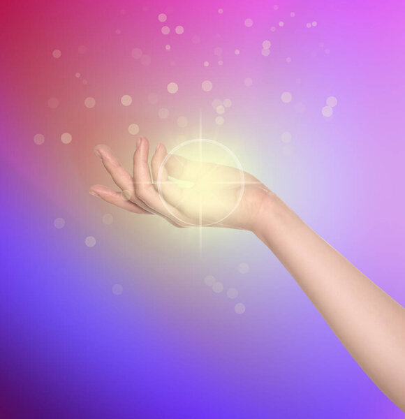 Woman holding concentrated healing energy in her hand, closeup