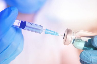 Şırıngayı ilaçla dolduran doktor, yakın çekim. Aşılama ve aşılama