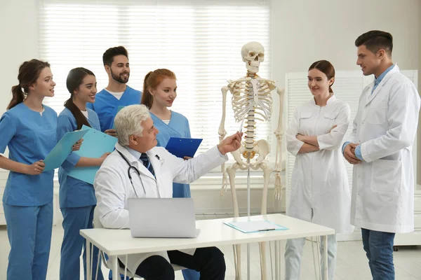 Professional orthopedist teaching medical students in clinic