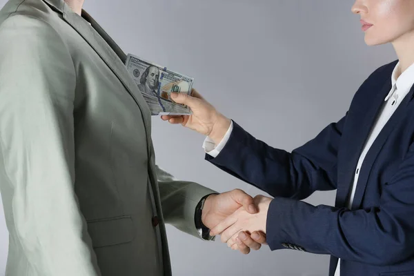 Woman Shaking Hands Man Offering Bribe Grey Background Closeup — 스톡 사진