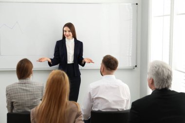 Ofisteki insanlarla çalışan profesyonel bir iş eğitmeni.