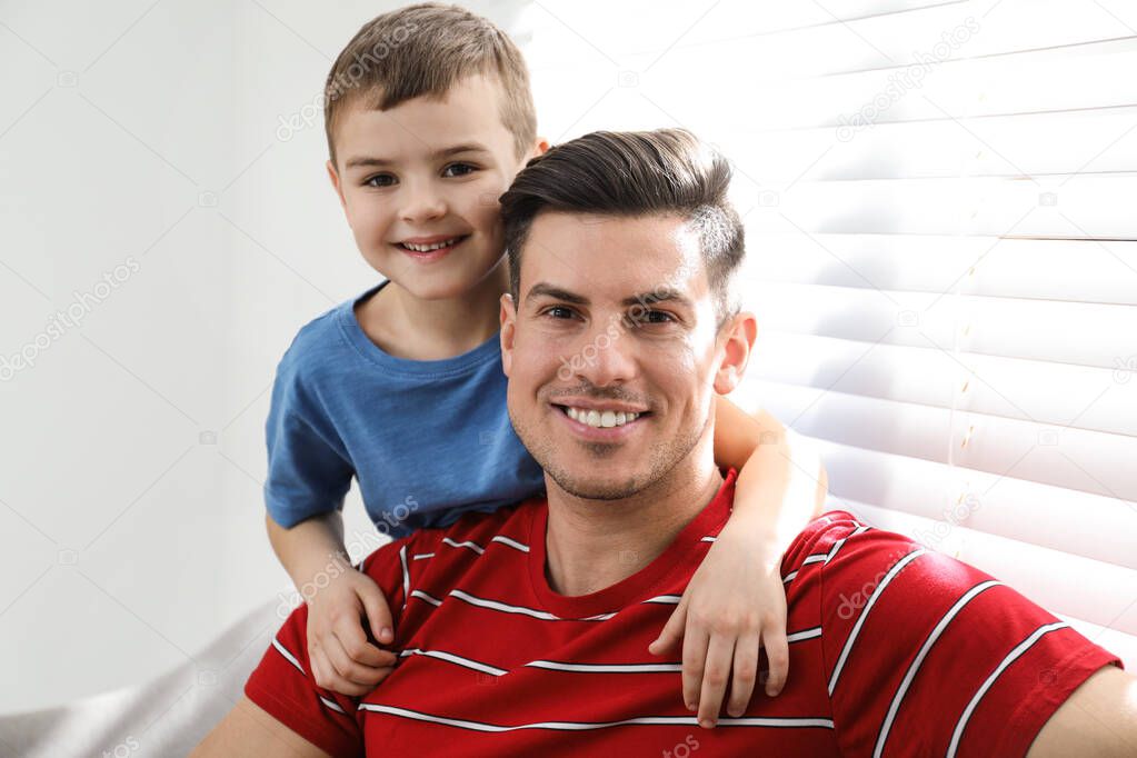 Dad and son spending time together at home. Happy Father's Day