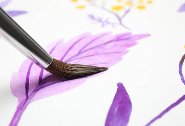 Painting leaf with watercolor on white paper, closeup