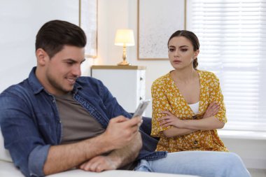 Evde erkek arkadaşının akıllı telefonuna bakan güvenilmez bir kadın. Kıskançlık.
