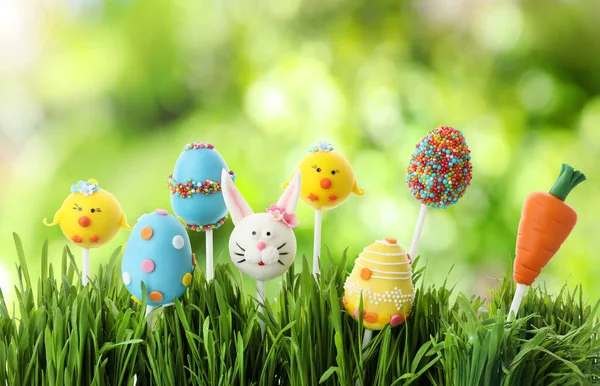 Different Delicious Cake Pops Easter Celebration Grass Blurred Green Background — Stock Photo, Image