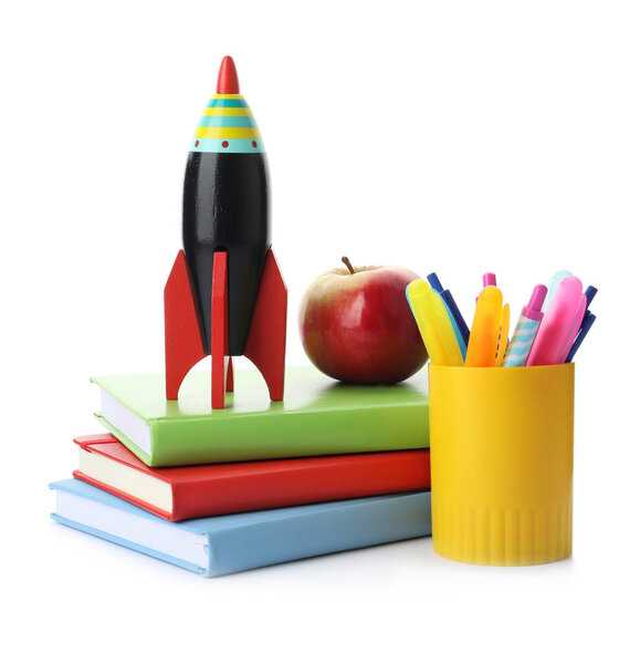 Bright toy rocket and school supplies on white background