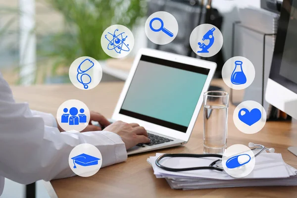 Medical student working with laptop indoors, closeup