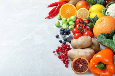 Açık gri mermer masa üzerinde C vitamini bakımından zengin ürünler. Metin için boşluk