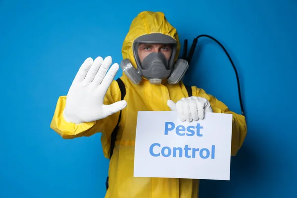 Hombre Con Traje Protector Con Rociador Insecticida Sosteniendo Signo Pest —  Fotos de Stock