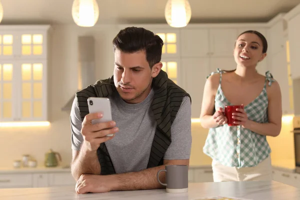 Distrustful Woman Peering Boyfriend Smartphone Home Jealousy Relationship — Stock Photo, Image