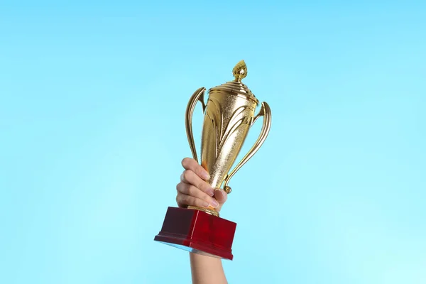 Woman Holding Gold Trophy Cup Light Blue Background Closeup — Stock Photo, Image