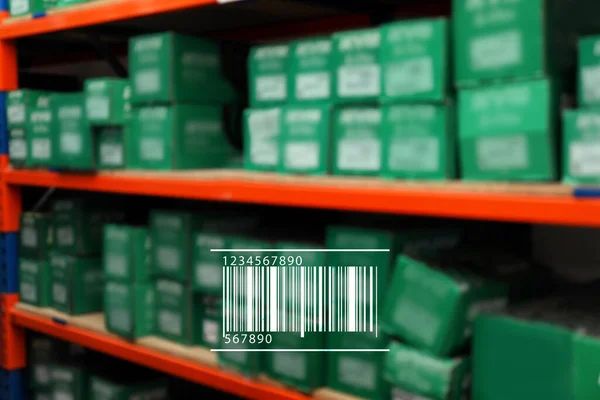 Barcode and blurred view of modern wholesale shop with merchandise