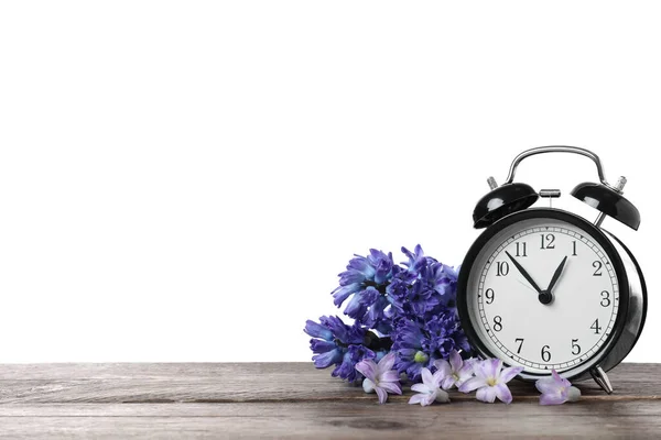 Black Alarm Clock Spring Flowers Wooden Table White Background Space — Stock Photo, Image