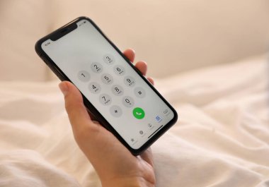 MYKOLAIV, UKRAINE - 16 Mart 2020: iPhone 11 'i elinde tutan kadın içeride, yakın plan