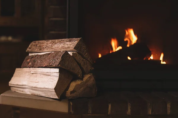 Pile of wood near fireplace indoors. Winter vacation