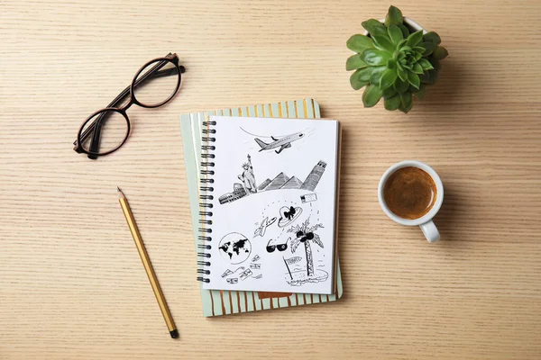 Flat lay composition with notebooks, coffee and glasses on wooden background