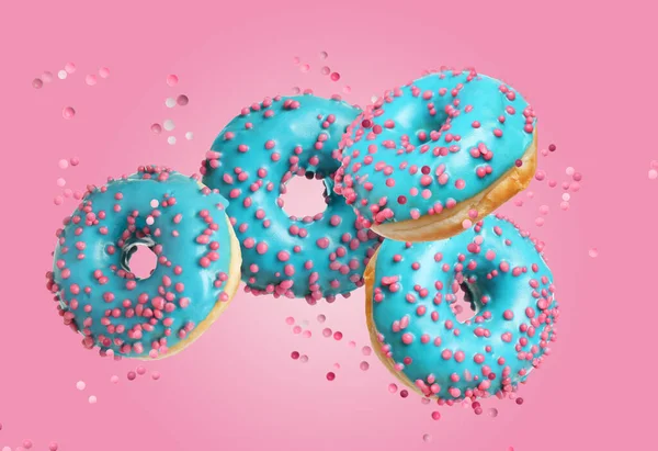 Set Falling Delicious Donuts Pink Background — Stock Photo, Image