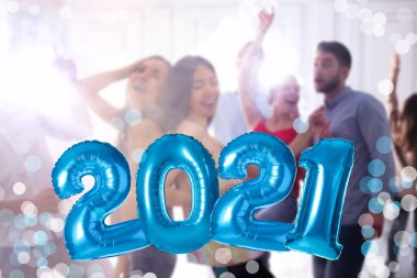 Mavi folyo 2021 balonları ve insanlar partide dans ediyor. 