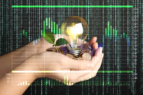 Woman with coins, light bulb and green plant against black background, closeup. Energy saving