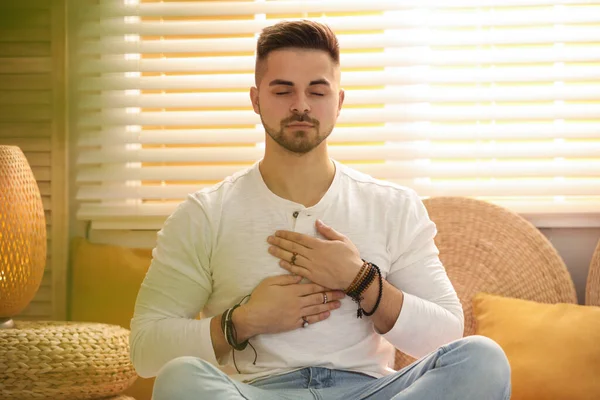 Young man during self-healing session in therapy room