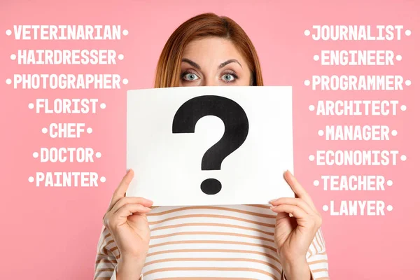 Puzzled woman with question mark sign choosing profession on pink background