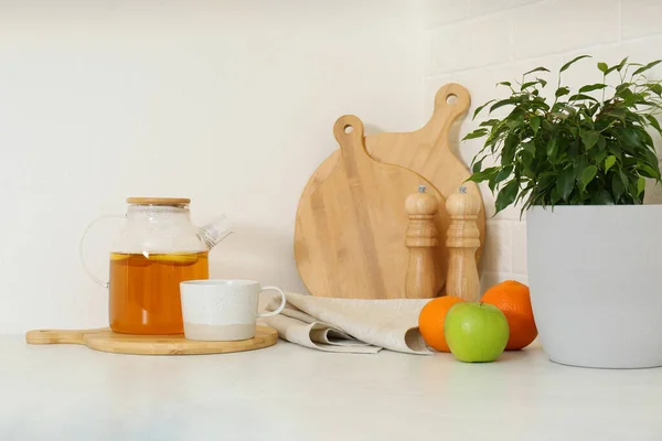 Different kitchen items and houseplant on countertop indoors