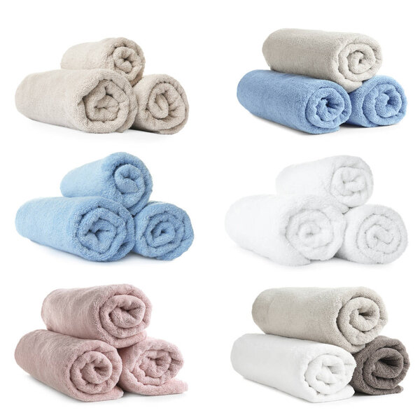 Set of rolled soft terry towels on white background