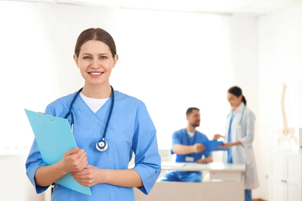 Portrait Young Doctor Clipboard Hospital Space Text Medical Service — Stock Photo, Image
