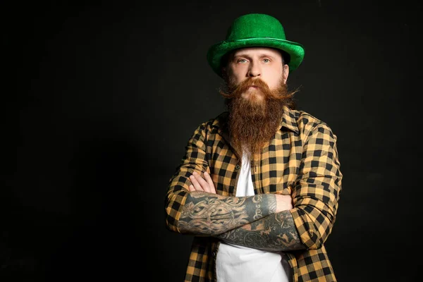 Bearded man in green hat on black background, space for text. St. Patrick\'s Day celebration
