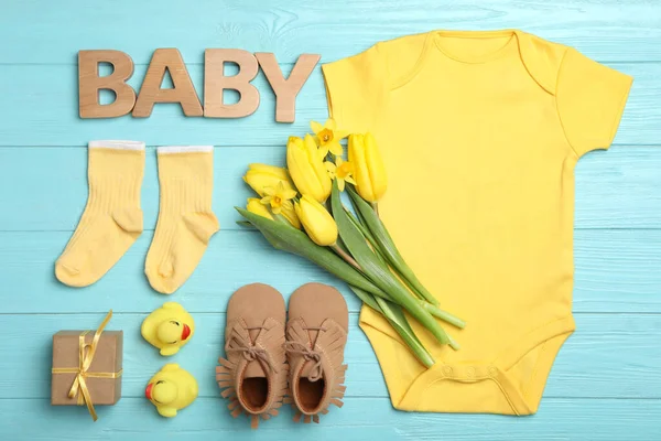 Flache Liegekomposition Mit Kinderkleidung Und Wort Baby Auf Hellblauem Holztisch — Stockfoto