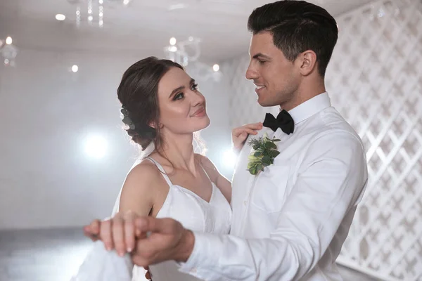 stock image Happy newlywed couple dancing together in festive hall