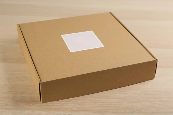 Closed Cardboard Box Wooden Table Closeup — Stock Photo, Image