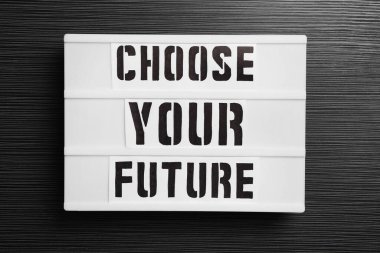 Üzerinde kelimeler olan bilgi panosu Geleceğinizi siyah ahşap masa üzerinde seçin, üst görünüm. Kariyer konsepti