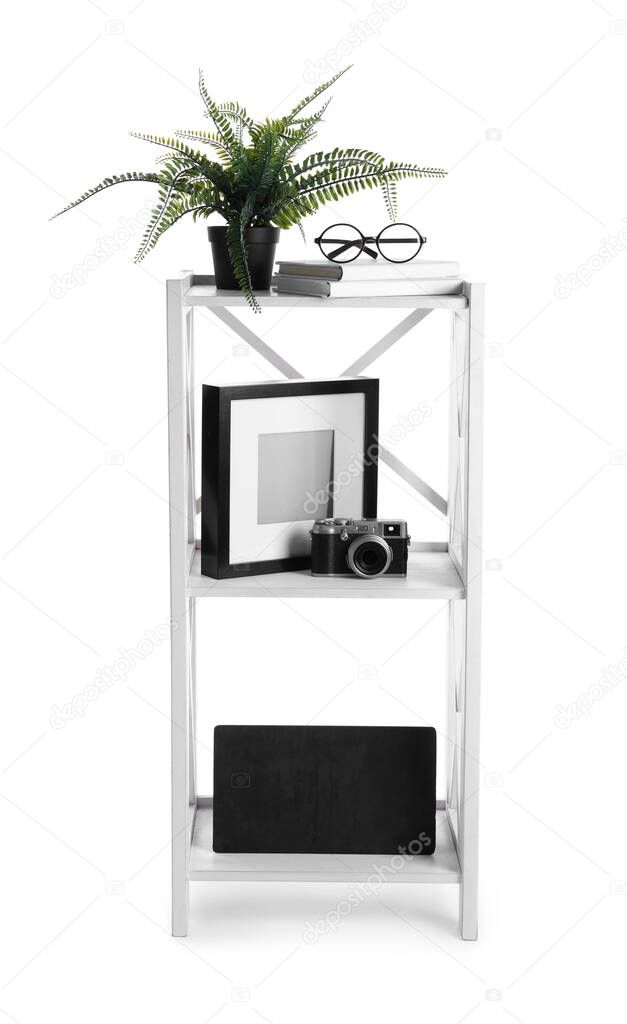 Wooden shelving unit with different items isolated on white