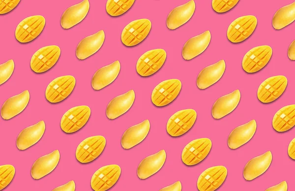 Pattern of cut mango fruits on pink background