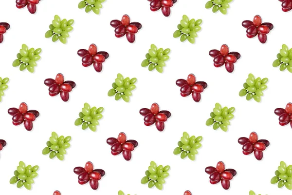 Pattern of red and green grapes on white background