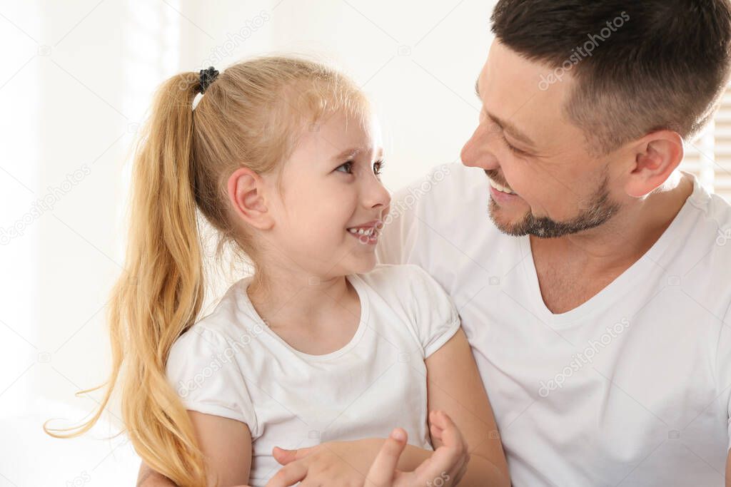 Dad and daughter spending time together at home. Happy Father's Day