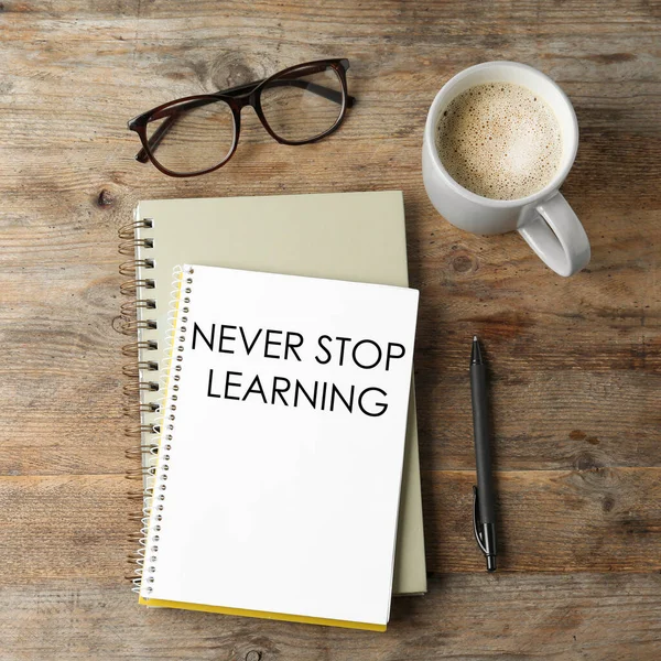 Notebook Phrase Never Stop Learning Glasses Cup Coffee Wooden Table — Stock Photo, Image