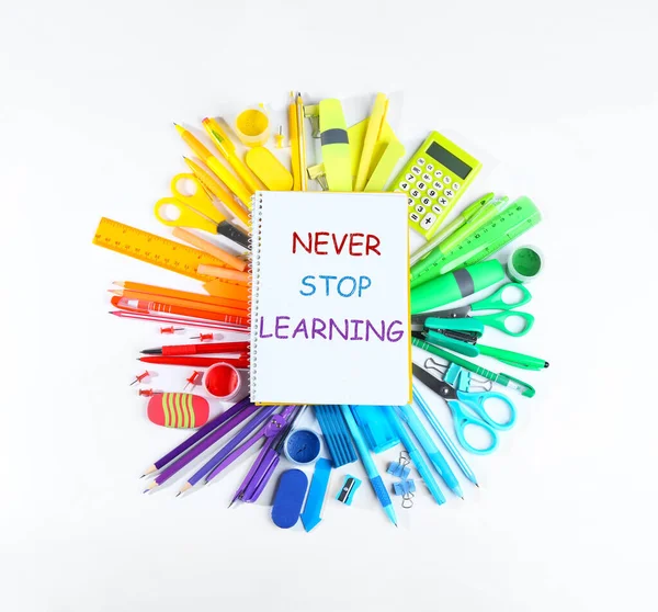 Notebook Phrase Never Stop Learning Different School Stationery White Background — Stock Photo, Image