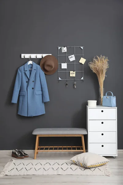 Hallway interior with stylish furniture, clothes and accessories