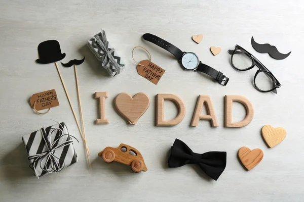 Flat lay composition with phrase I LOVE DAD on white background. Happy Father\'s day