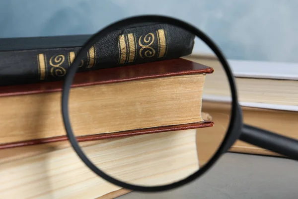 Looking Magnifying Glass Stack Vintage Books Grey Table Closeup Search — Stock Photo, Image