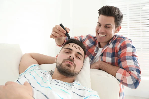 Man Writing Word Fool Face Sleeping Friend Indoors First April — Stock Photo, Image