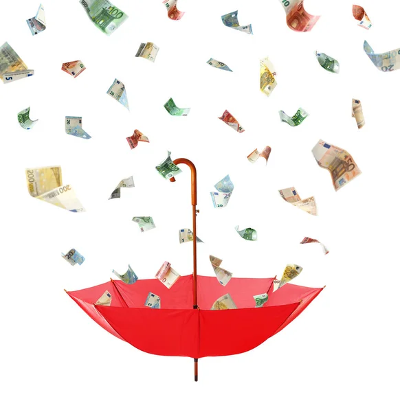 Euro banknotes falling into red umbrella on white background