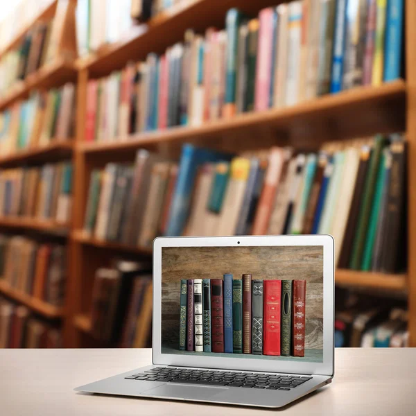 Digital library concept. Modern laptop on table indoors