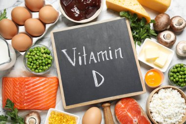 Beyaz mermer masa üzerinde D vitamini bakımından zengin ürünlerle düz konum