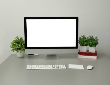 Bilgisayar ve ev bitkilerinin olduğu modern bir iş yeri. İç tasarım