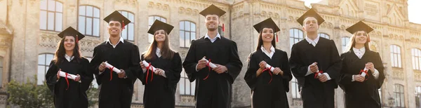 Glada Studenter Med Diplom Nära Campus Banderolldesign — Stockfoto